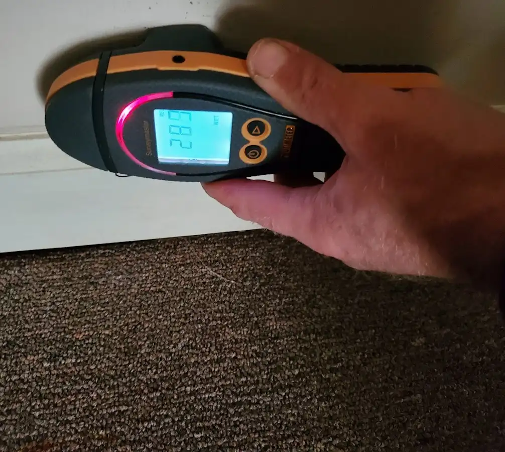 Moisture detection at baseboard during Storm Damage Restoration in Sunset Hills